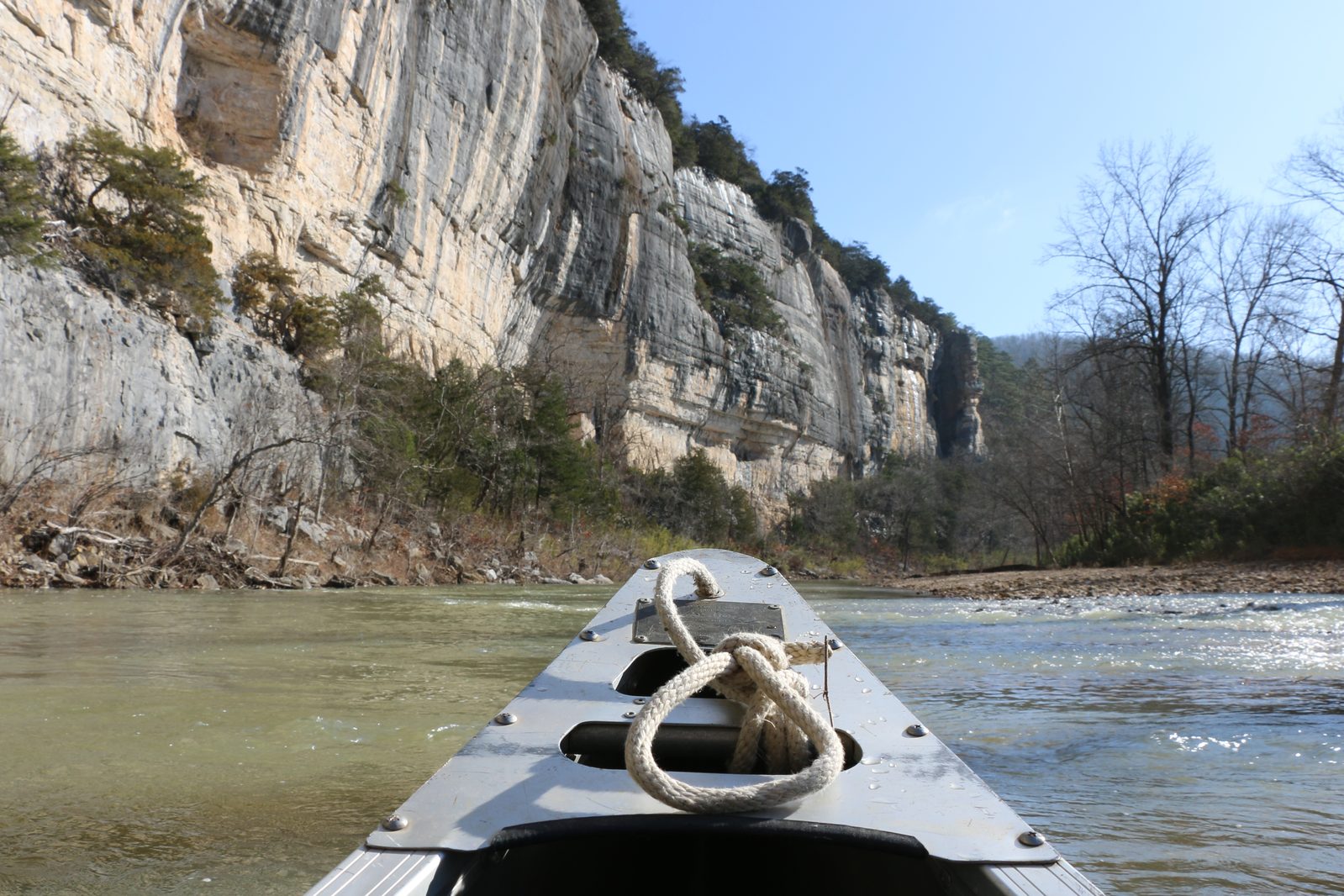View from the bow of a canoe with Roark Bluff glimmering ahead on the Buffalo River